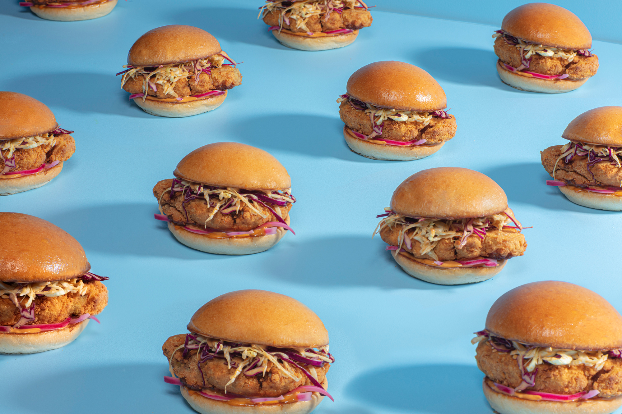 A field of burgers on a blue background